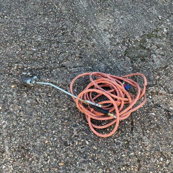 Used gas weed burning lance for garden weed control.