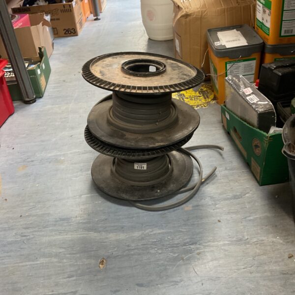 Stacked plastic welding wire spools for metal fabrication.