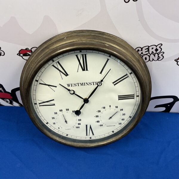 Vintage Westminster barometer clock with Roman numerals and barometer dial.