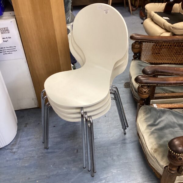 White Bentwood stacking chairs with chrome legs, mid-century modern style.