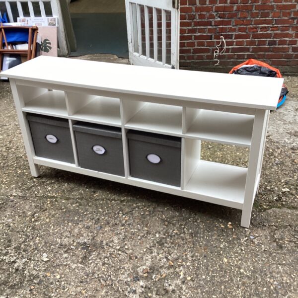 White sideboard storage unit with fabric boxes for hallway or living room.