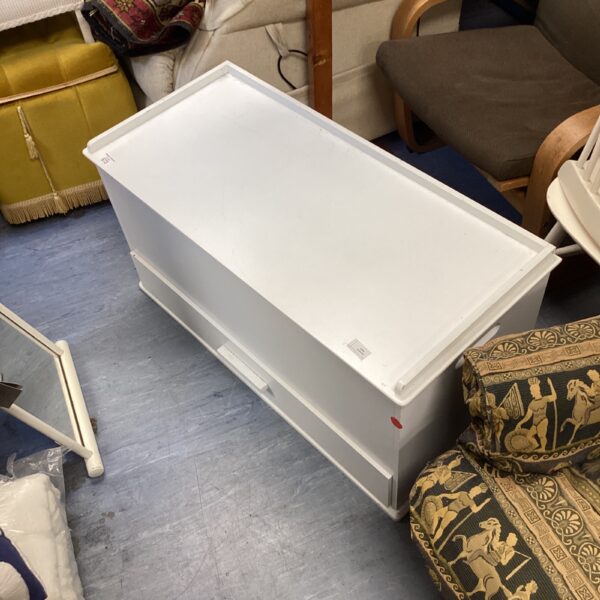 White storage bench for hallway or bedroom seating.