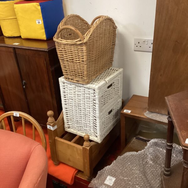 Vintage wicker storage baskets and pine magazine rack collection.