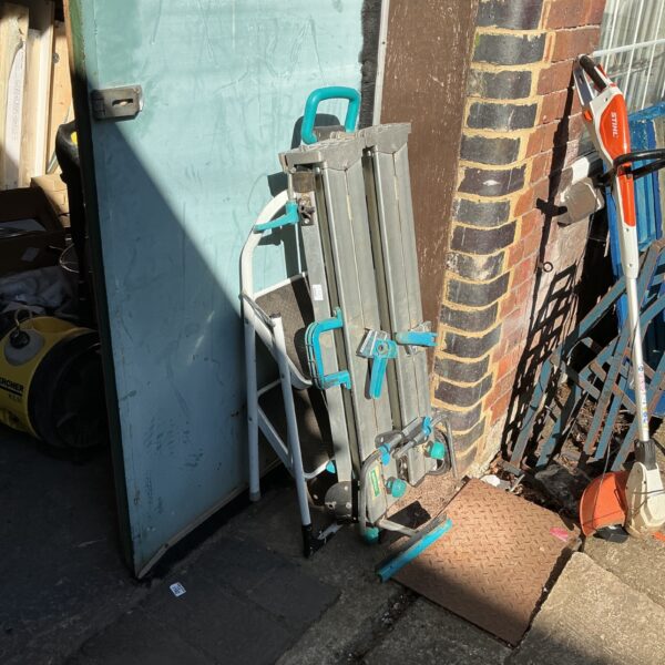 Portable Wolfcraft workbench in a garden setting.