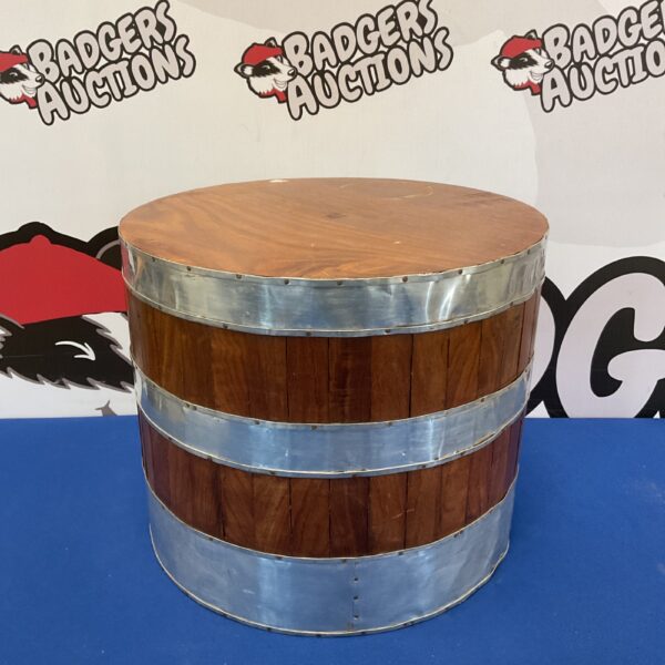 Vintage wooden barrel footstool with metal bands for rustic decor.