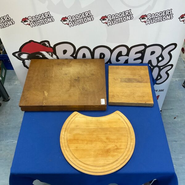 Lot of three wooden chopping boards for kitchen use.