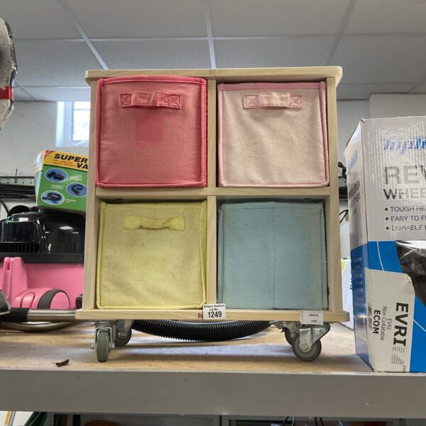 Wooden cube storage unit with four compartments on casters.