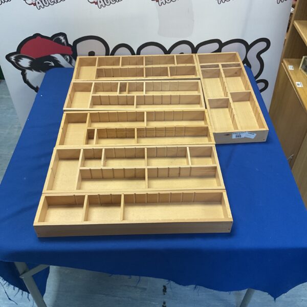 Vintage wooden drawer organiser with multiple compartments for storage.