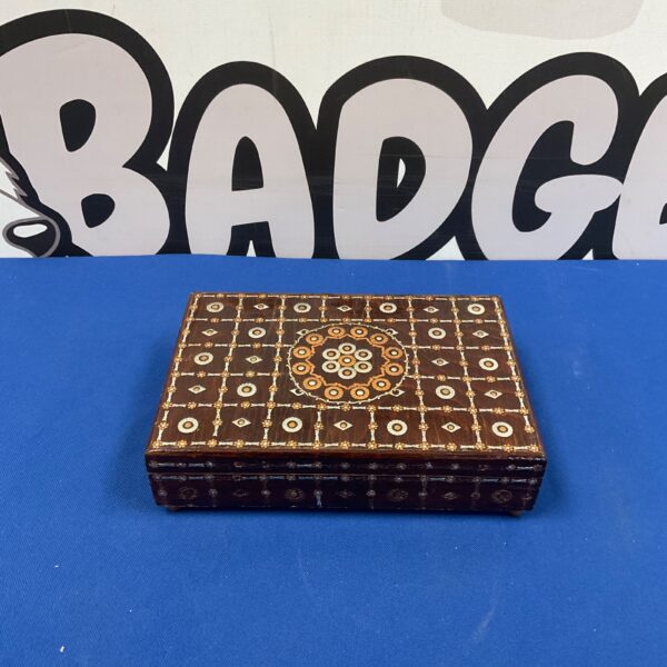 Vintage wooden jewellery box with detailed metal inlay design.