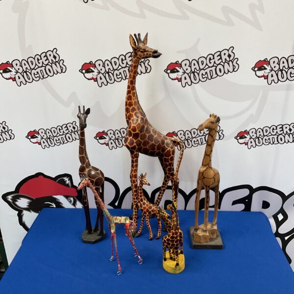 Collection of wooden and metal giraffe ornaments for home decor.