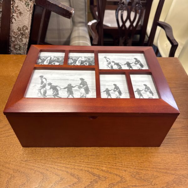 Front view of a vintage wooden photo memory box with six photos displayed.