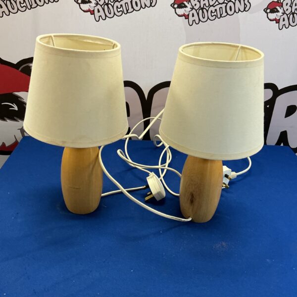 Pair of vintage wooden table lamps with fabric shades.