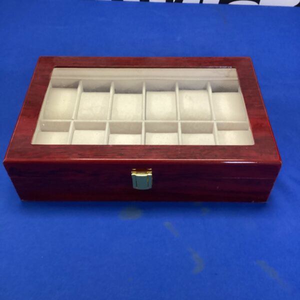 Reddish-brown wooden watch box with twelve individual slots.