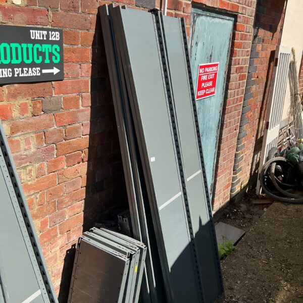 Used metal workshop shelving units for garage or industrial storage.