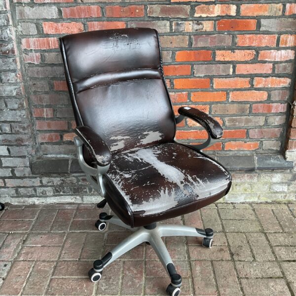 Worn faux leather office chair with swivel base.