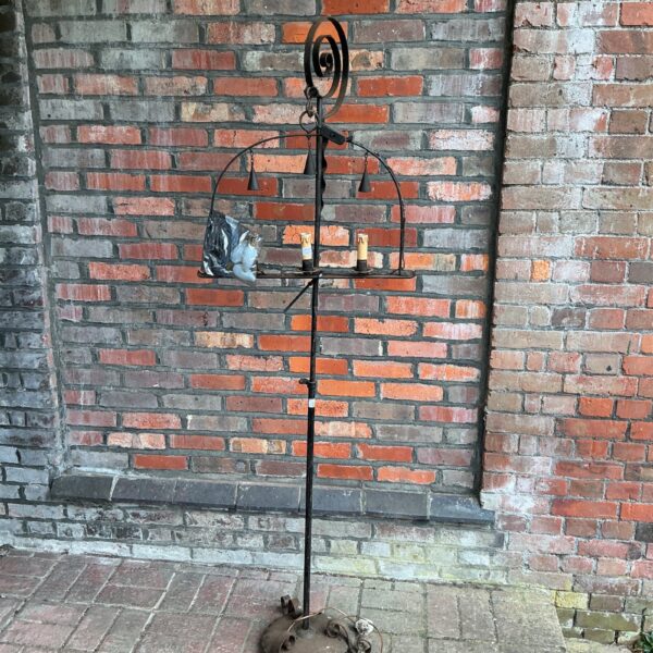 Vintage wrought iron standard lamp with decorative detailing.