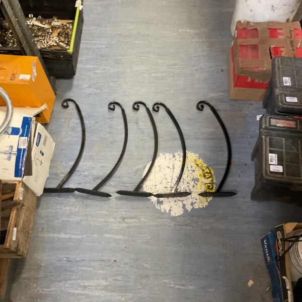 Vintage wrought iron wall bracket with curved design.