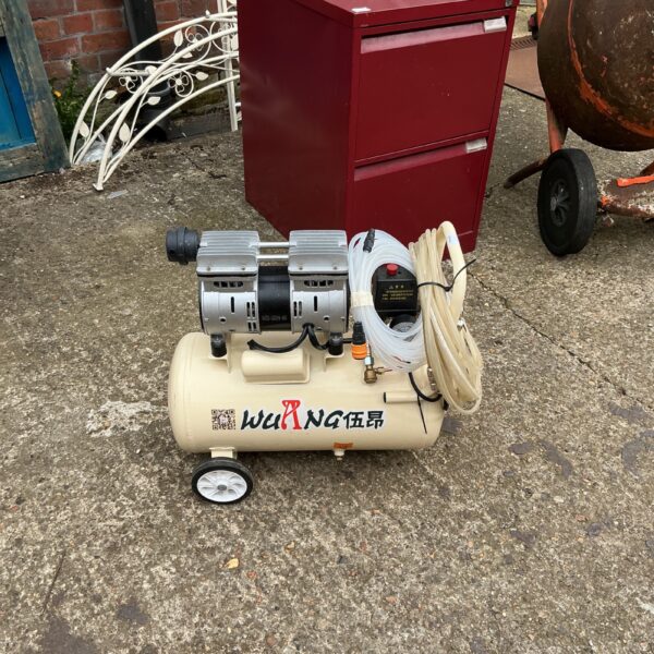Vintage Wu Ranger air compressor with metal tank for workshop use.