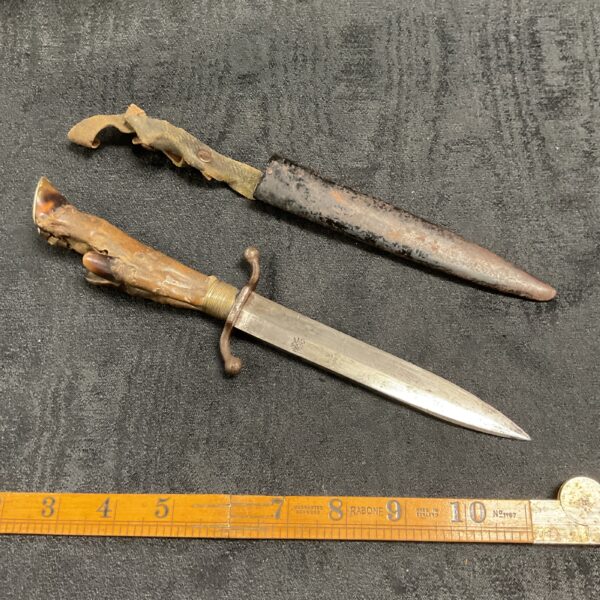 Antique German deer hoof trench knife with scabbard, WWI collectible.