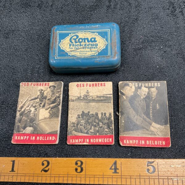 Vintage Rona tin containing three WWII German miniature booklets.