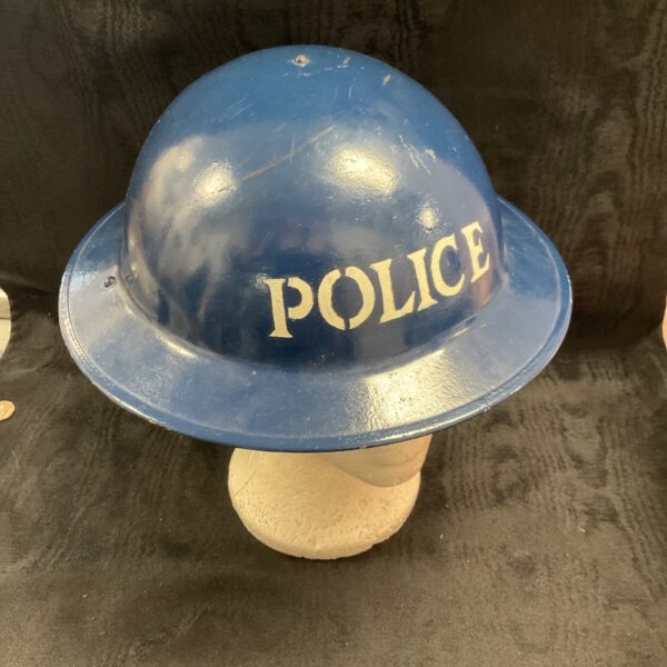 Vintage WWII Brodie helmet marked "POLICE" in blue.