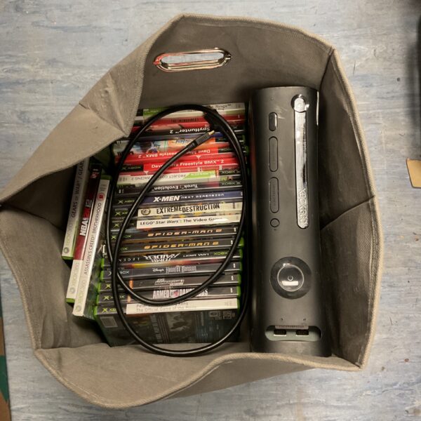Xbox 360 console with a collection of video games.