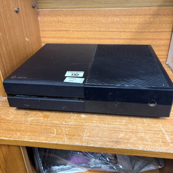 Black Microsoft Xbox One gaming console, front view.
