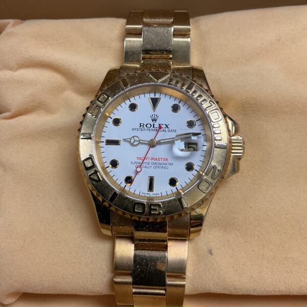 Gold tone Yacht Master style watch with detailed dial.