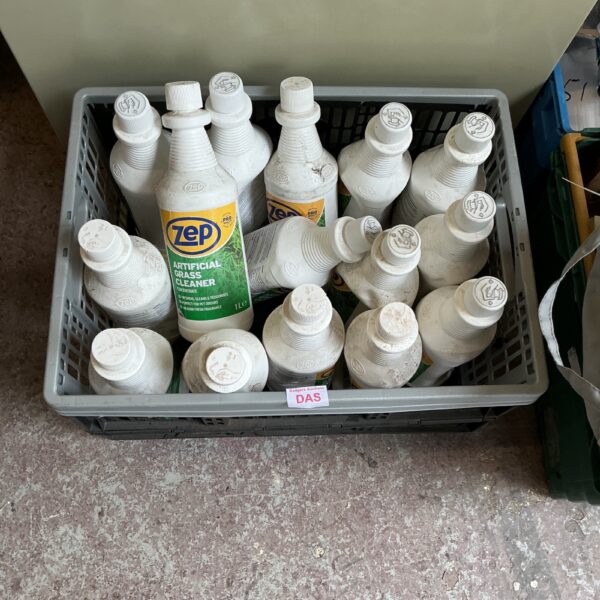 Lot of Zep artificial grass cleaner bottles for garden maintenance.