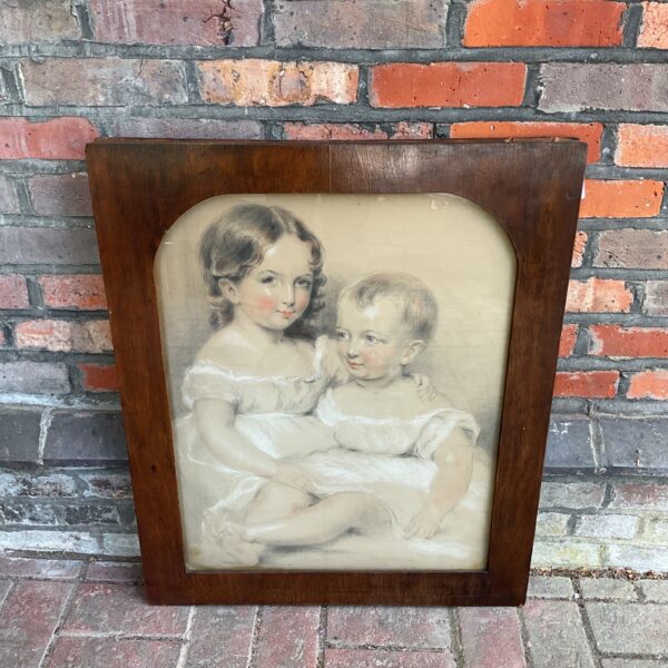 19th century pastel portrait of two little sisters in a frame.