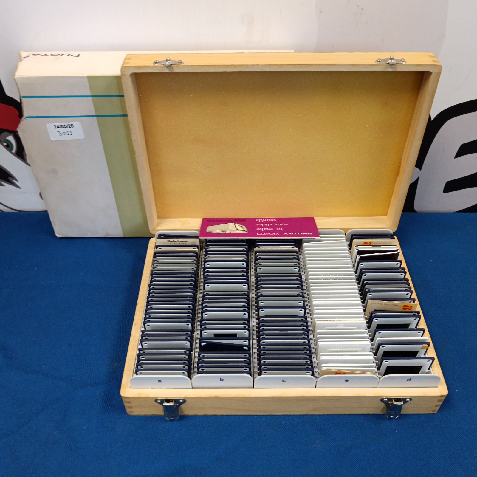 Vintage wooden box containing 35mm slides of trains for collectors.