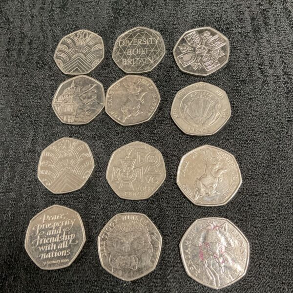 Collection of twelve 50p coins including Peter Rabbit and Paddington Bear.
