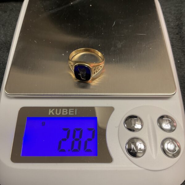Close-up of a 9ct gold signet ring, size U, showing detail.