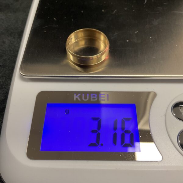 Close-up of a 9ct gold wedding band, size S.