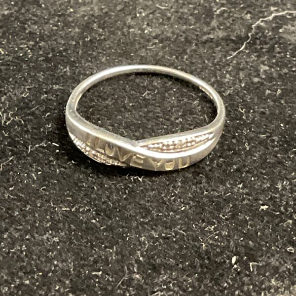 Close-up of 9ct white gold love ring, size O.