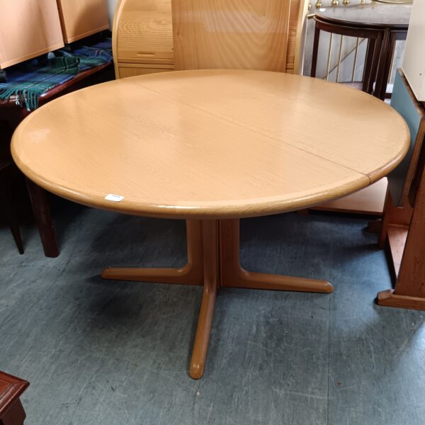 A large round kovby danish extending dining table
