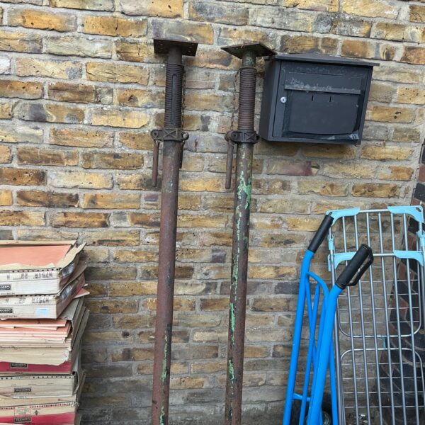 Pair of used Ackro props for construction support.