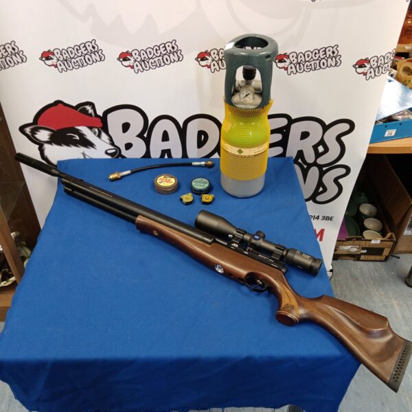 Air Arms S510 air rifle with Zeiss scope and accessories on blue cloth.