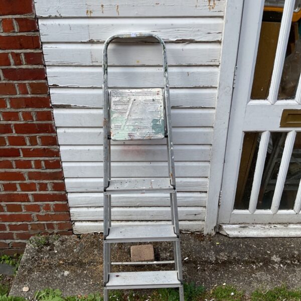 Vintage aluminium step ladder with four steps, ideal for DIY projects.