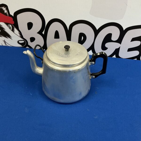 Vintage aluminium teapot with a curved handle and spout.