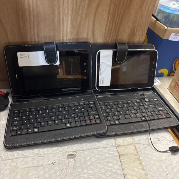 Two black Android tablets with keyboard cases displayed.