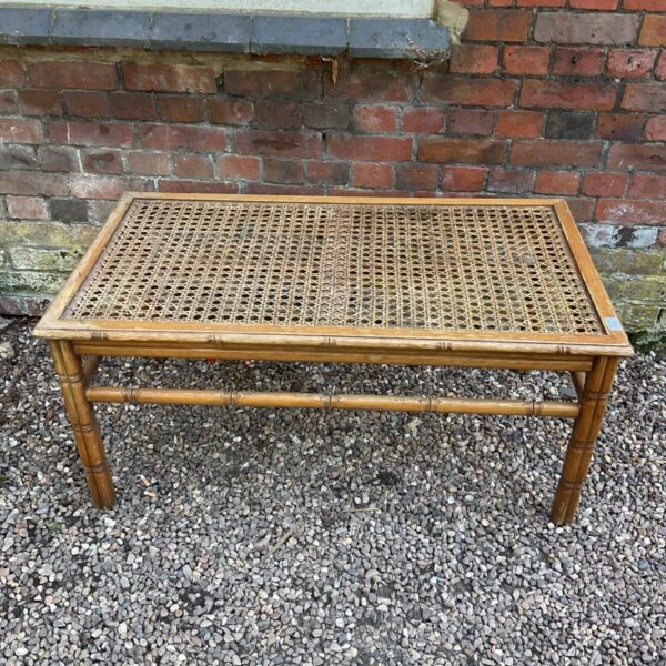 Antique bamboo garden table with woven rattan top.