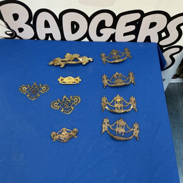 Antique brass drawer handles with floral design, vintage cabinet hardware.