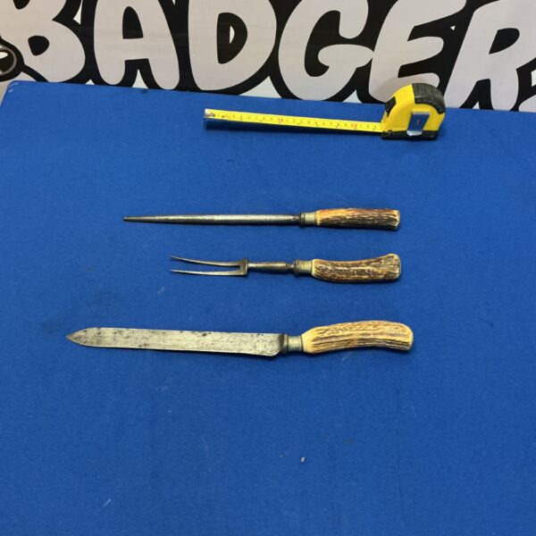 Antique carving set with natural horn handles and silver-plated blades.
