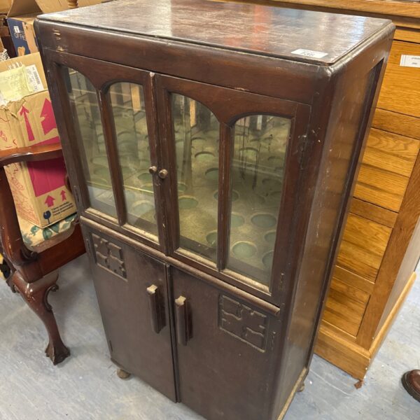 Antique cocktail cabinet with glass front and mirrored interior.