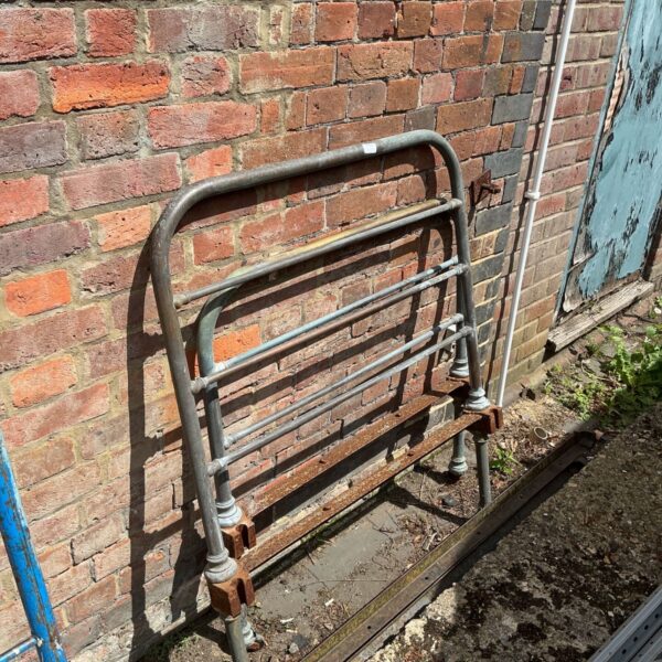 Antique copper bed frame with weathered patina and Victorian design.