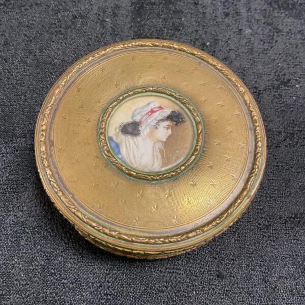 Antique French powder box with hand-painted portrait miniature on gilt bronze lid.