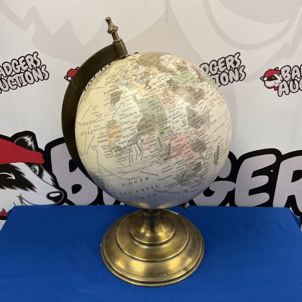 Antique globe on brass base, detailed world map, vintage collectible.