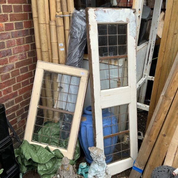 Pair of antique leaded windows with wooden frames.