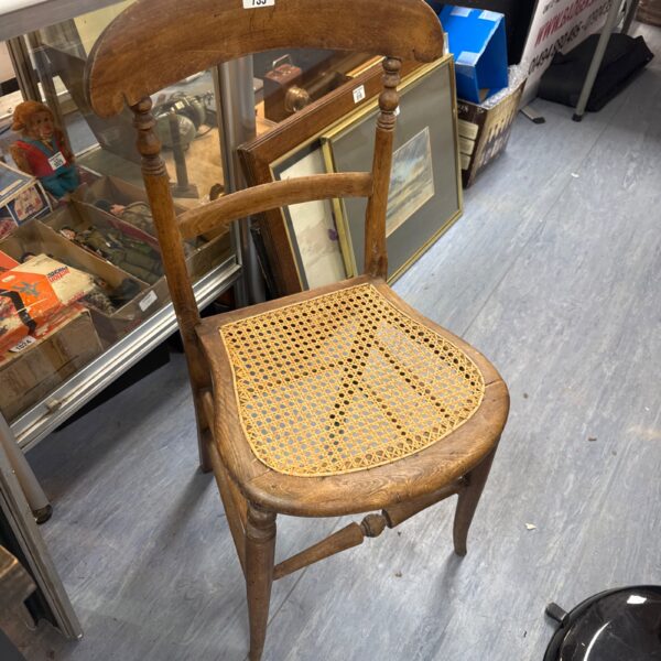 Antique mahogany chair with woven rattan seat and back.
